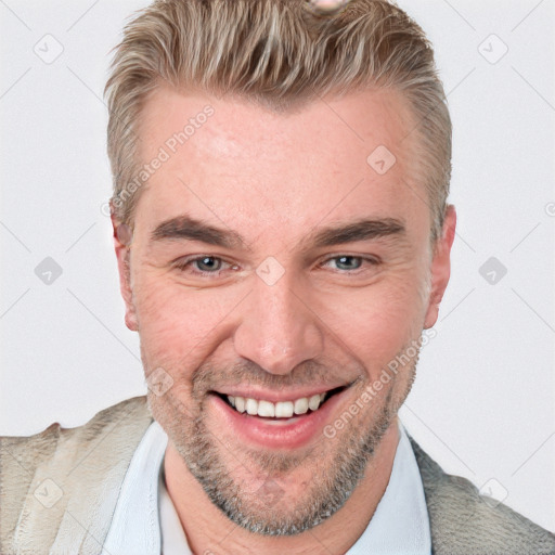 Joyful white adult male with short  brown hair and blue eyes