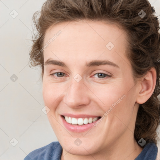 Joyful white young-adult female with medium  brown hair and blue eyes