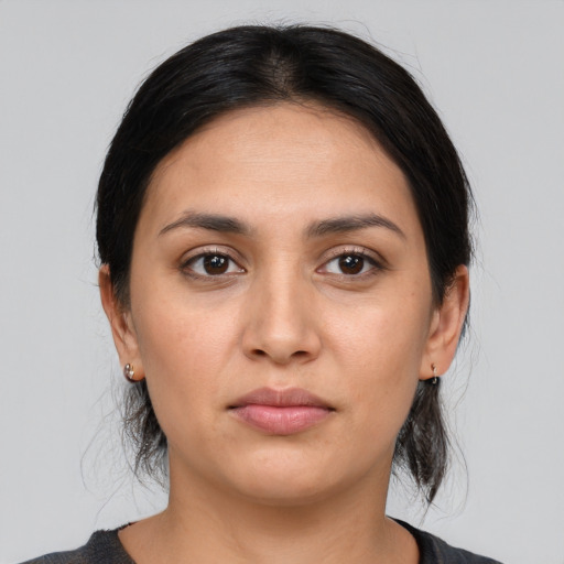 Joyful white young-adult female with medium  brown hair and brown eyes