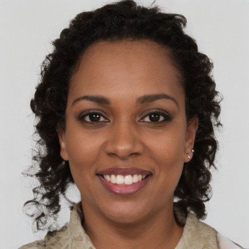 Joyful black young-adult female with medium  brown hair and brown eyes