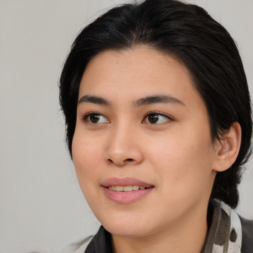 Joyful asian young-adult female with medium  black hair and brown eyes