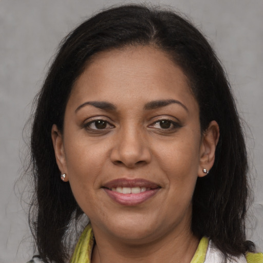 Joyful black adult female with medium  brown hair and brown eyes