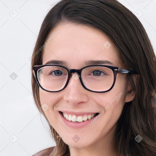 Joyful white young-adult female with long  brown hair and blue eyes