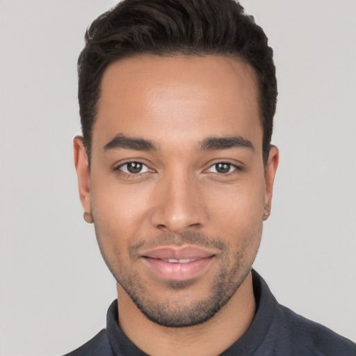 Joyful white young-adult male with short  black hair and brown eyes