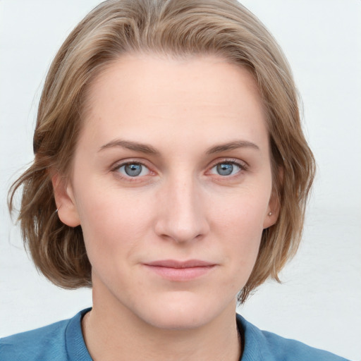 Joyful white young-adult female with medium  brown hair and blue eyes