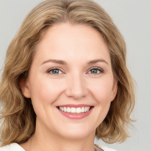 Joyful white young-adult female with medium  brown hair and green eyes