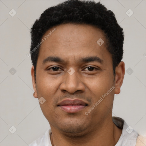 Joyful latino adult male with short  black hair and brown eyes