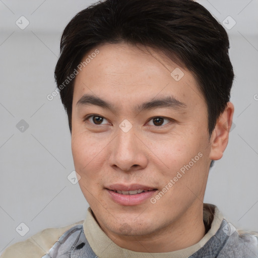 Joyful asian young-adult male with short  brown hair and brown eyes