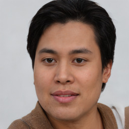 Joyful asian young-adult male with short  brown hair and brown eyes