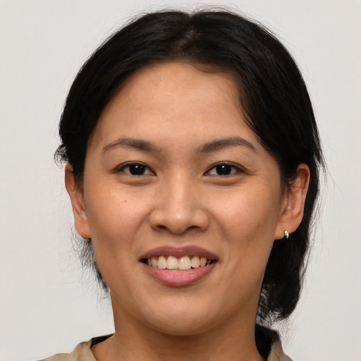 Joyful asian young-adult female with medium  brown hair and brown eyes