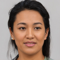 Joyful asian young-adult female with medium  black hair and brown eyes