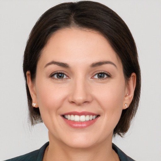 Joyful white young-adult female with medium  brown hair and brown eyes