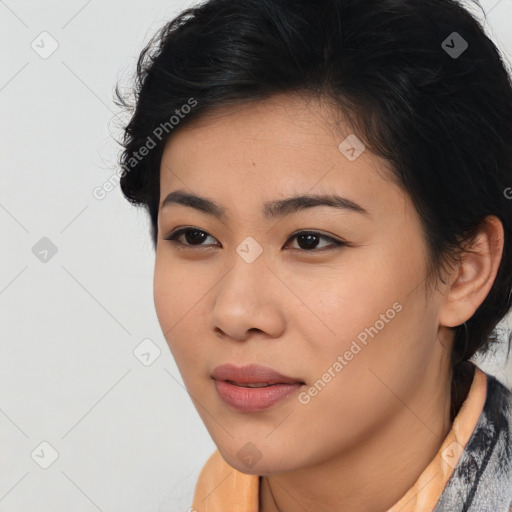 Joyful asian young-adult female with short  black hair and brown eyes