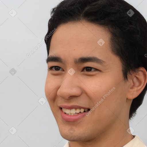 Joyful white young-adult male with short  black hair and brown eyes