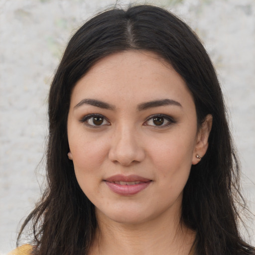 Joyful latino young-adult female with long  brown hair and brown eyes