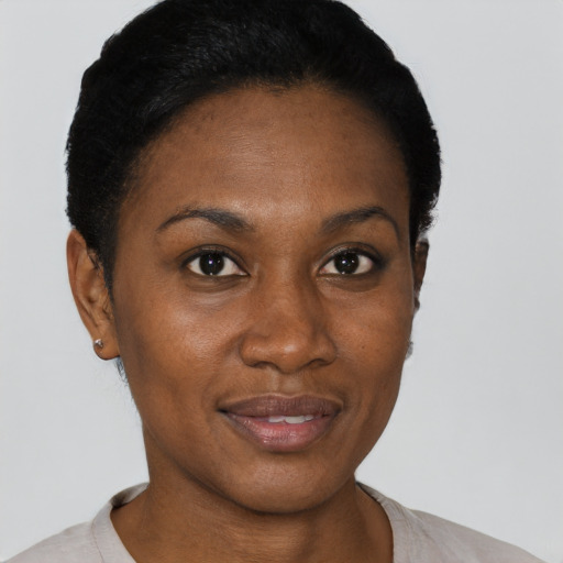Joyful black young-adult female with short  black hair and brown eyes