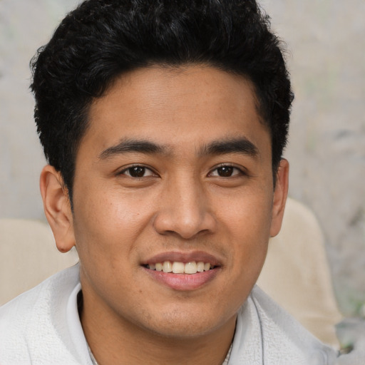 Joyful asian young-adult male with short  brown hair and brown eyes