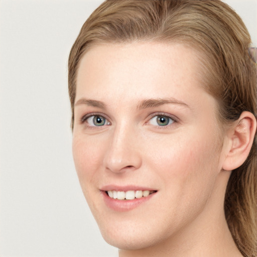 Joyful white young-adult female with long  brown hair and blue eyes