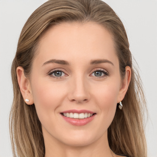 Joyful white young-adult female with long  brown hair and blue eyes