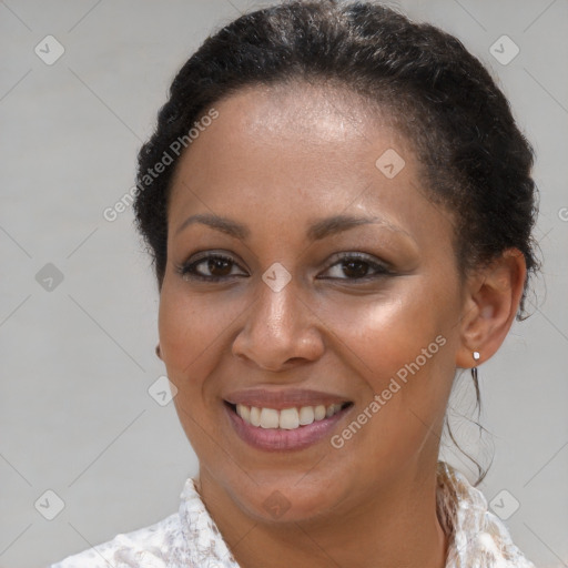 Joyful black young-adult female with short  brown hair and brown eyes