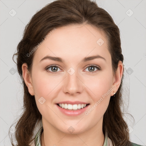 Joyful white young-adult female with medium  brown hair and green eyes