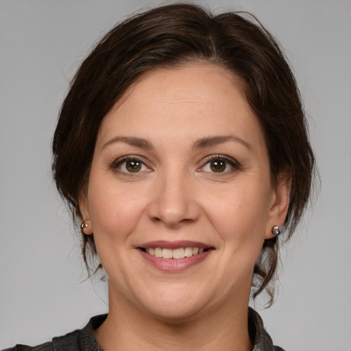 Joyful white adult female with medium  brown hair and brown eyes