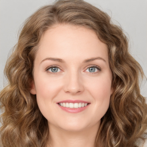 Joyful white young-adult female with long  brown hair and green eyes