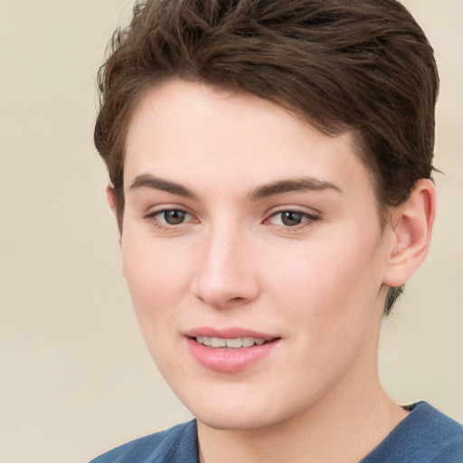 Joyful white young-adult female with short  brown hair and grey eyes