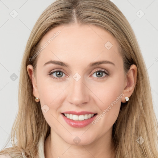 Joyful white young-adult female with long  brown hair and blue eyes