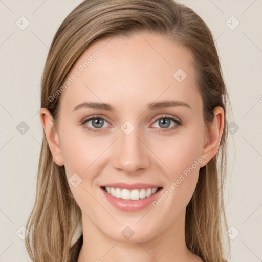 Joyful white young-adult female with long  brown hair and blue eyes