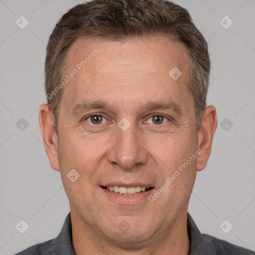 Joyful white adult male with short  brown hair and brown eyes