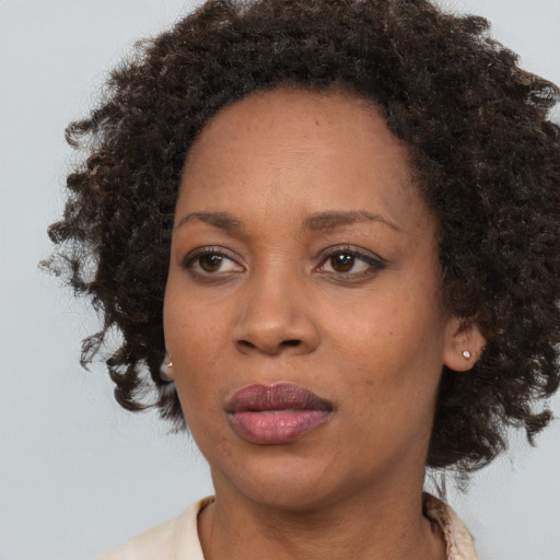 Neutral black young-adult female with medium  brown hair and brown eyes
