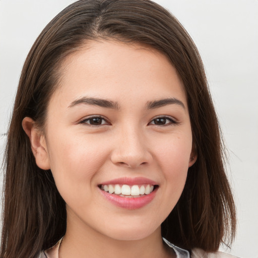 Joyful white young-adult female with long  brown hair and brown eyes