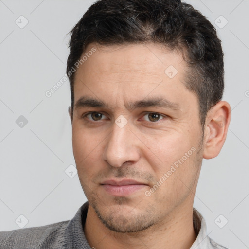 Joyful white adult male with short  brown hair and brown eyes