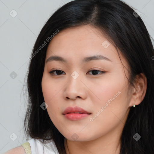 Joyful asian young-adult female with long  brown hair and brown eyes