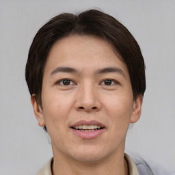 Joyful asian young-adult male with short  brown hair and brown eyes