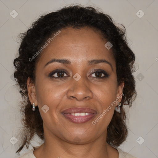 Joyful black adult female with medium  brown hair and brown eyes