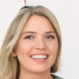 Joyful white young-adult female with long  brown hair and green eyes