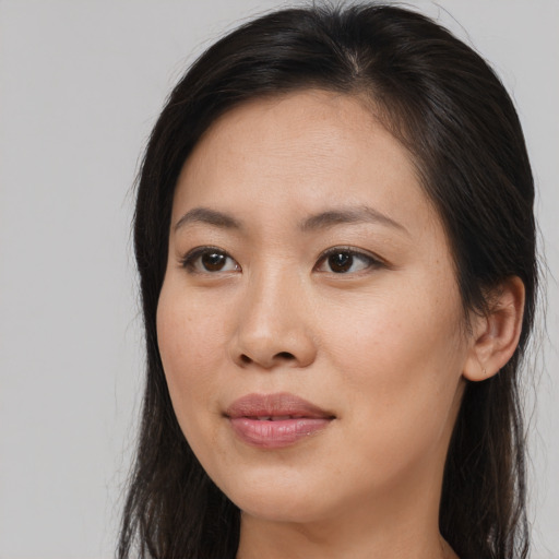 Joyful asian young-adult female with long  brown hair and brown eyes