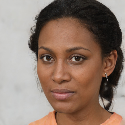 Joyful black young-adult female with medium  brown hair and brown eyes