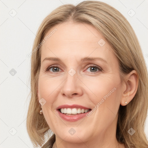 Joyful white adult female with long  brown hair and brown eyes