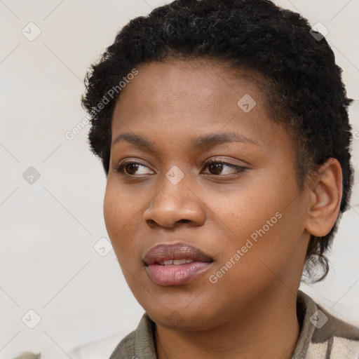 Joyful black young-adult female with short  brown hair and brown eyes
