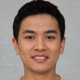 Joyful asian young-adult male with short  black hair and brown eyes