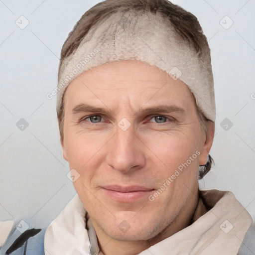 Joyful white adult male with short  brown hair and grey eyes