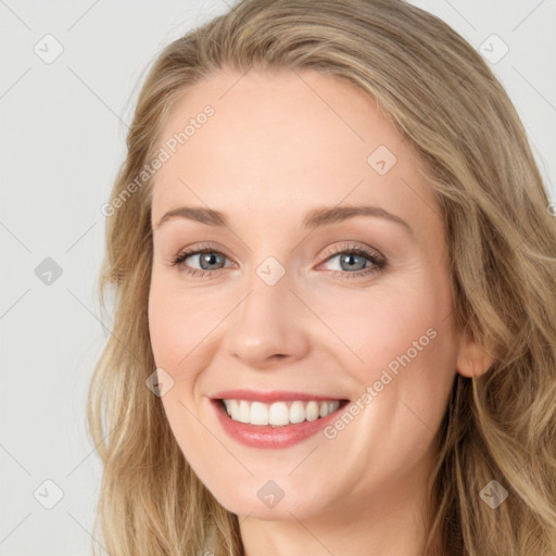 Joyful white young-adult female with long  brown hair and blue eyes