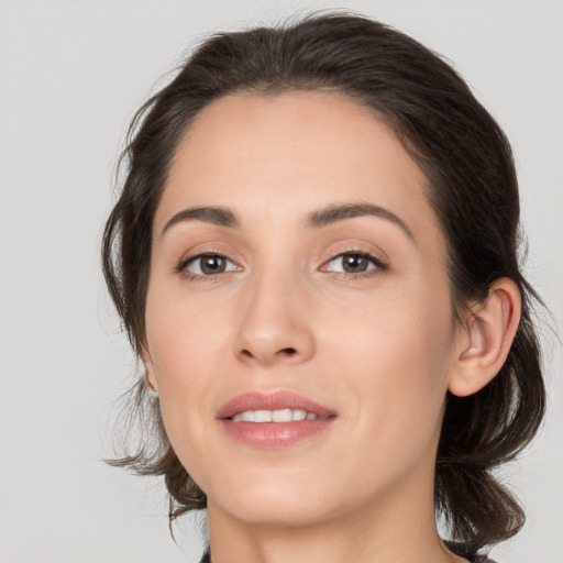 Joyful white young-adult female with medium  brown hair and brown eyes