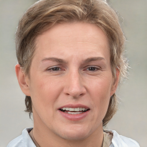 Joyful white adult female with short  brown hair and grey eyes