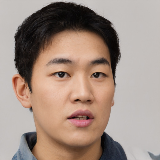 Neutral asian young-adult male with short  brown hair and brown eyes