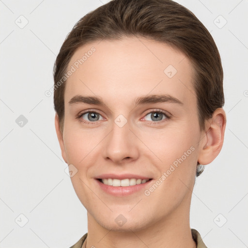 Joyful white young-adult female with short  brown hair and grey eyes