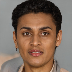 Joyful latino young-adult male with short  brown hair and brown eyes